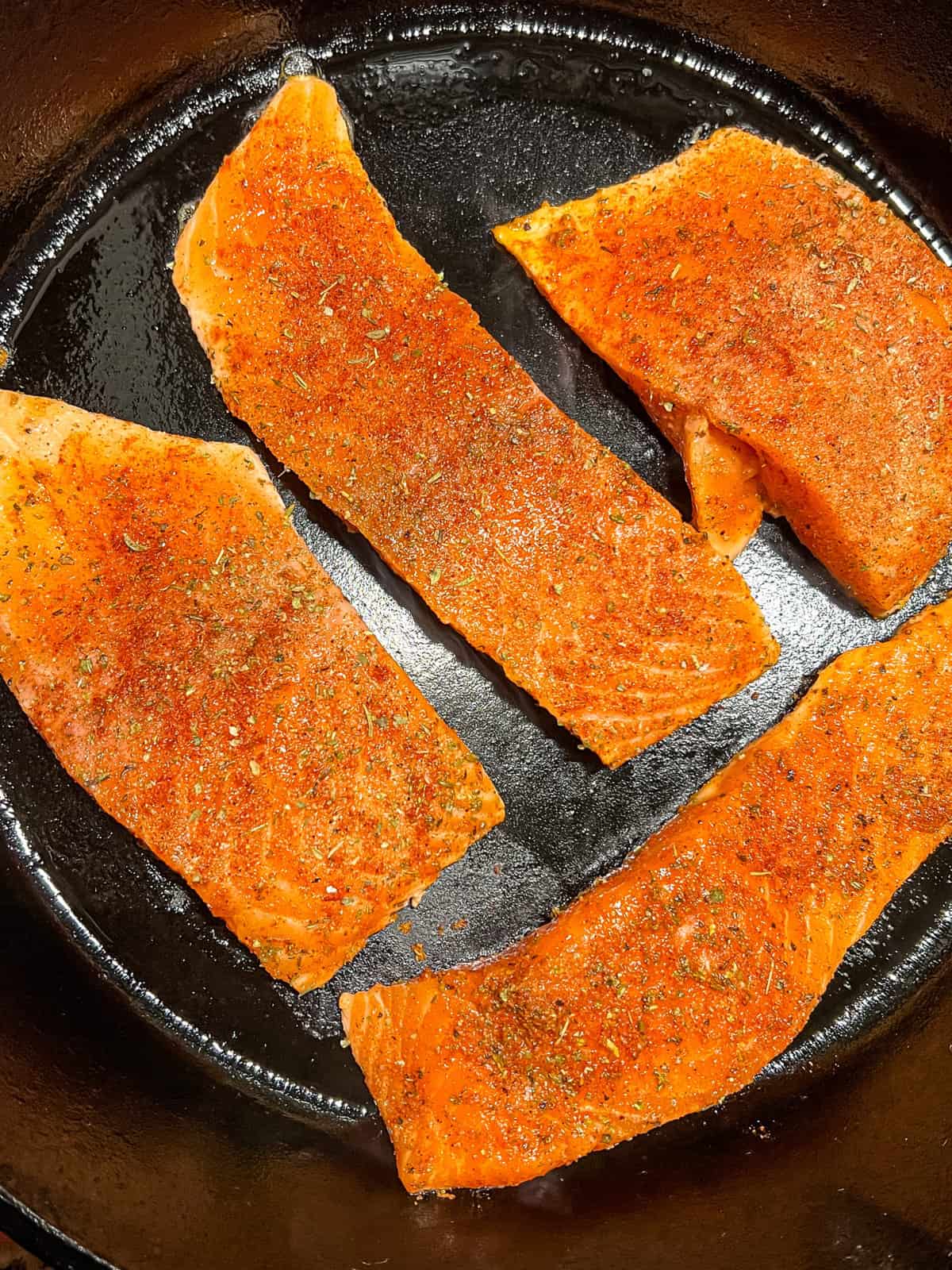 salmon cooking in a skillet