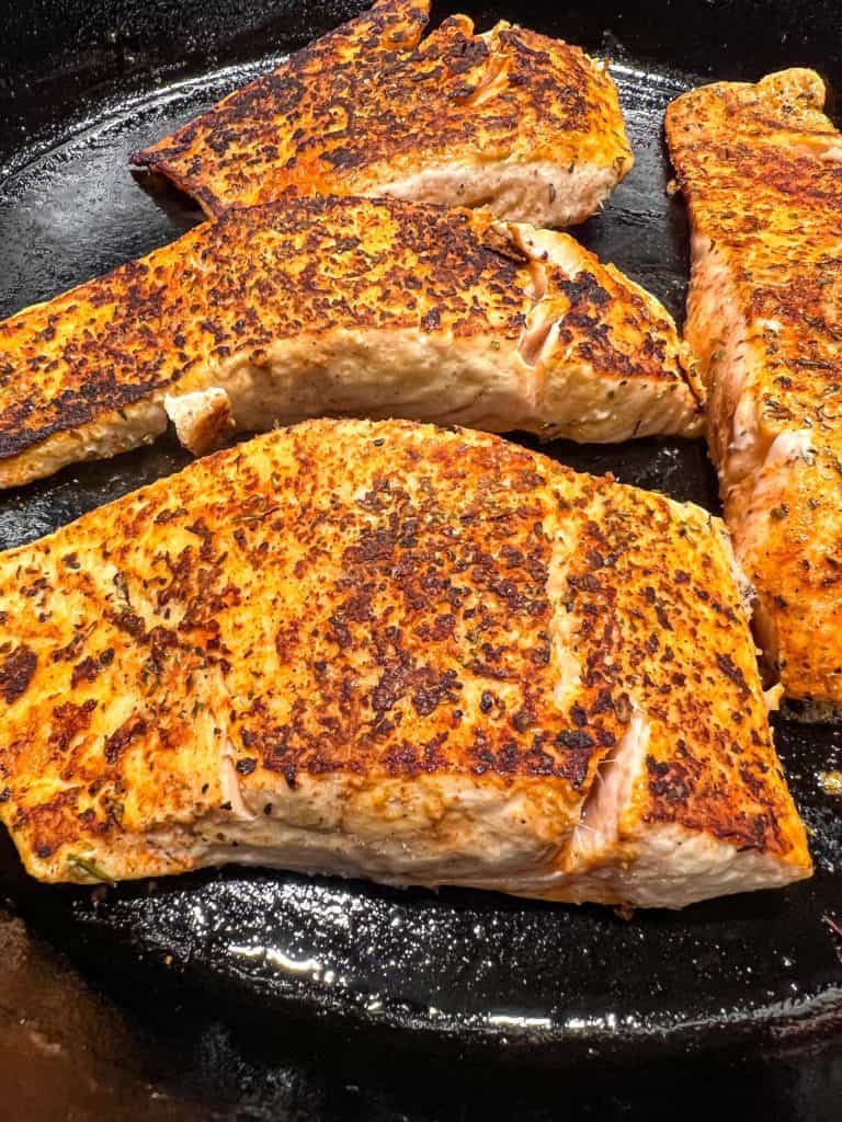 blackened salmon in a skillet