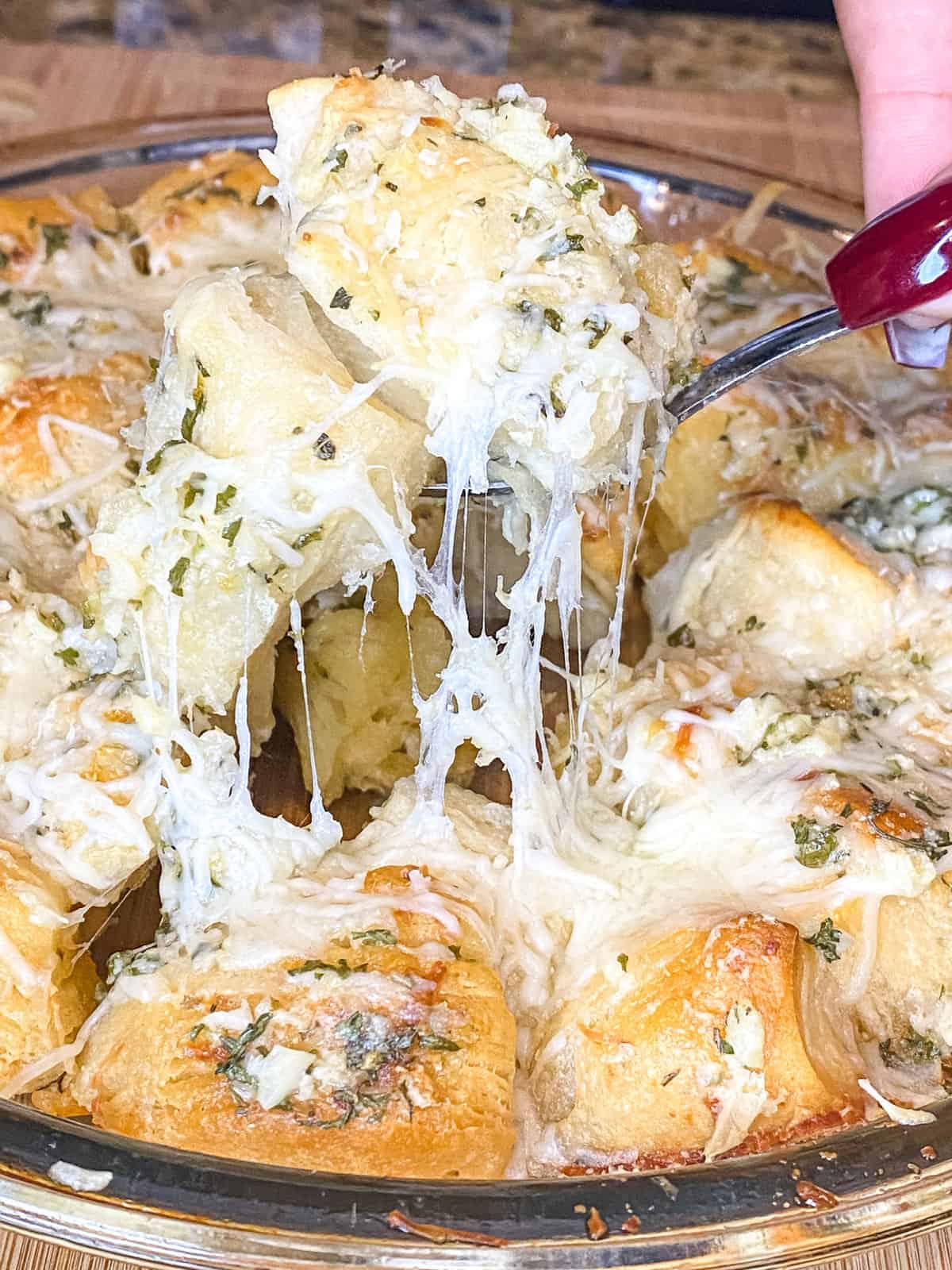 picture of garlic butter knots with a cheese pull