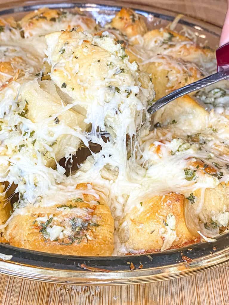 picture of garlic butter knots with a cheese pull