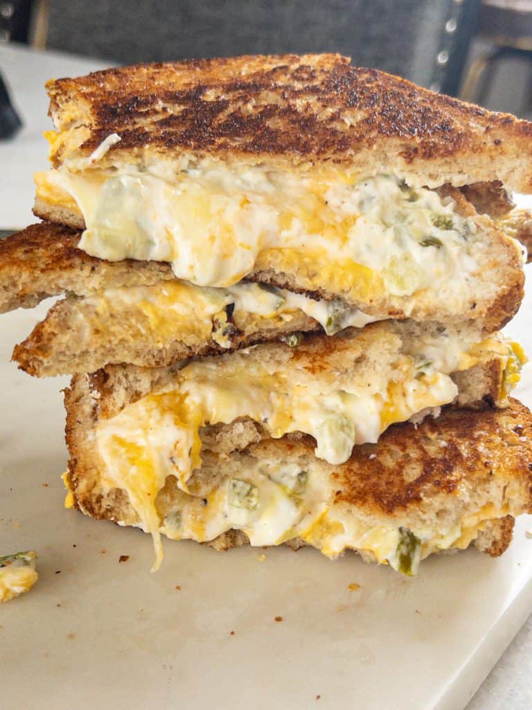 jalapeno popper sandwich cut in half stacked on top of each other