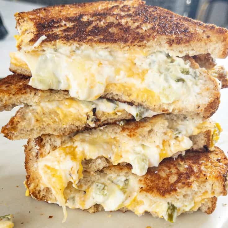 jalapeno popper sandwich cut in half stacked on top of each other