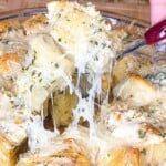 picture of garlic butter knots with a cheese pull