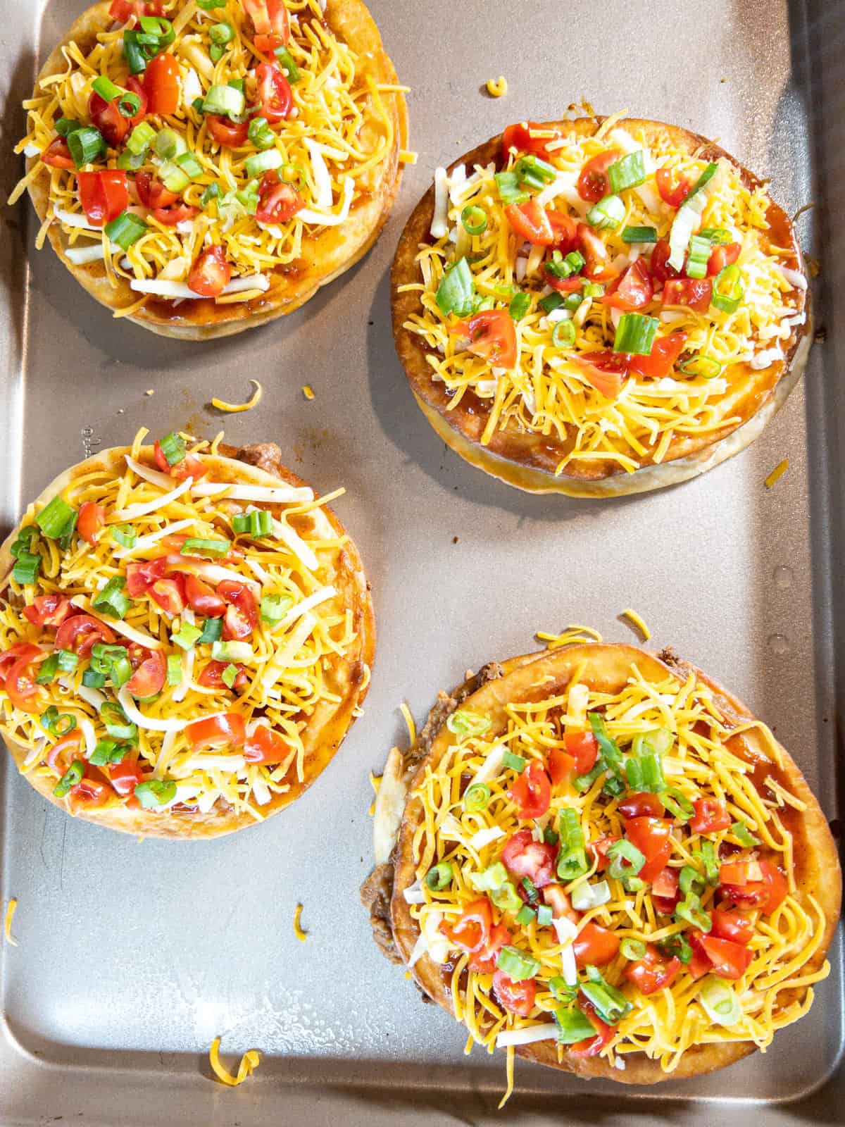 assembled Mexican pizzas on a baking sheet