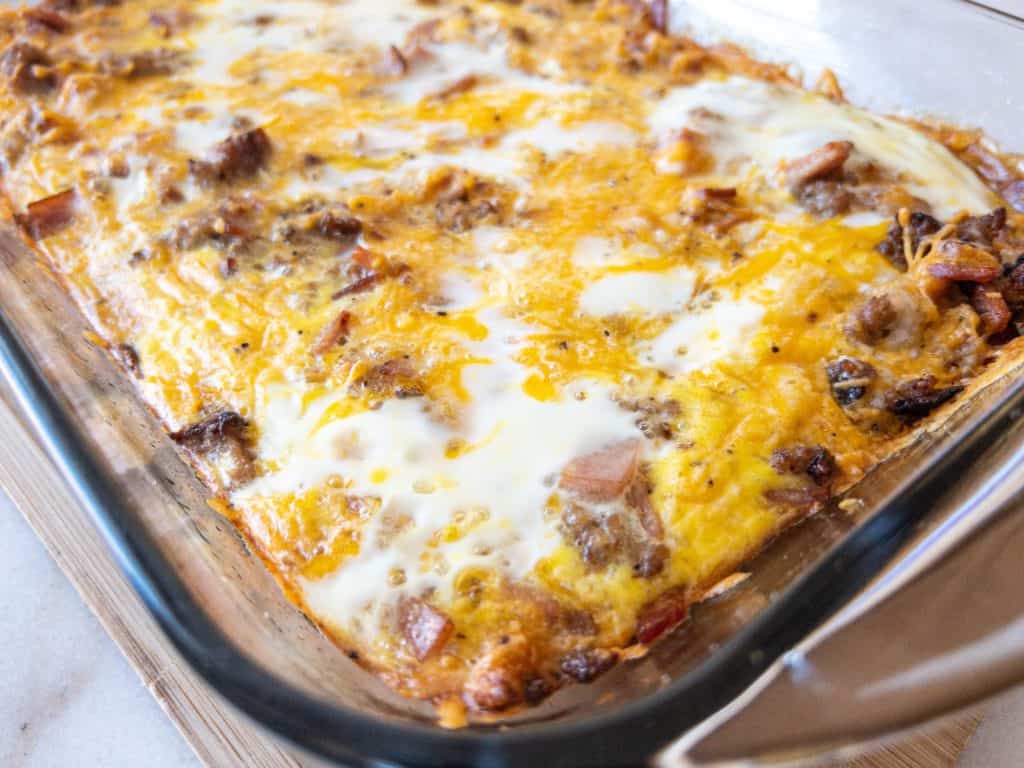 cheesy ham and cheese croissant casserole in a baking dish