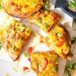 Mexican pizza on a cutting board cut into quarter