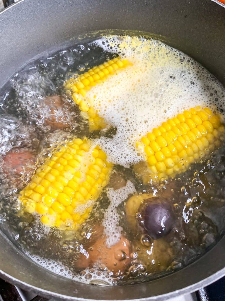 corn and potatoes boiling in water
