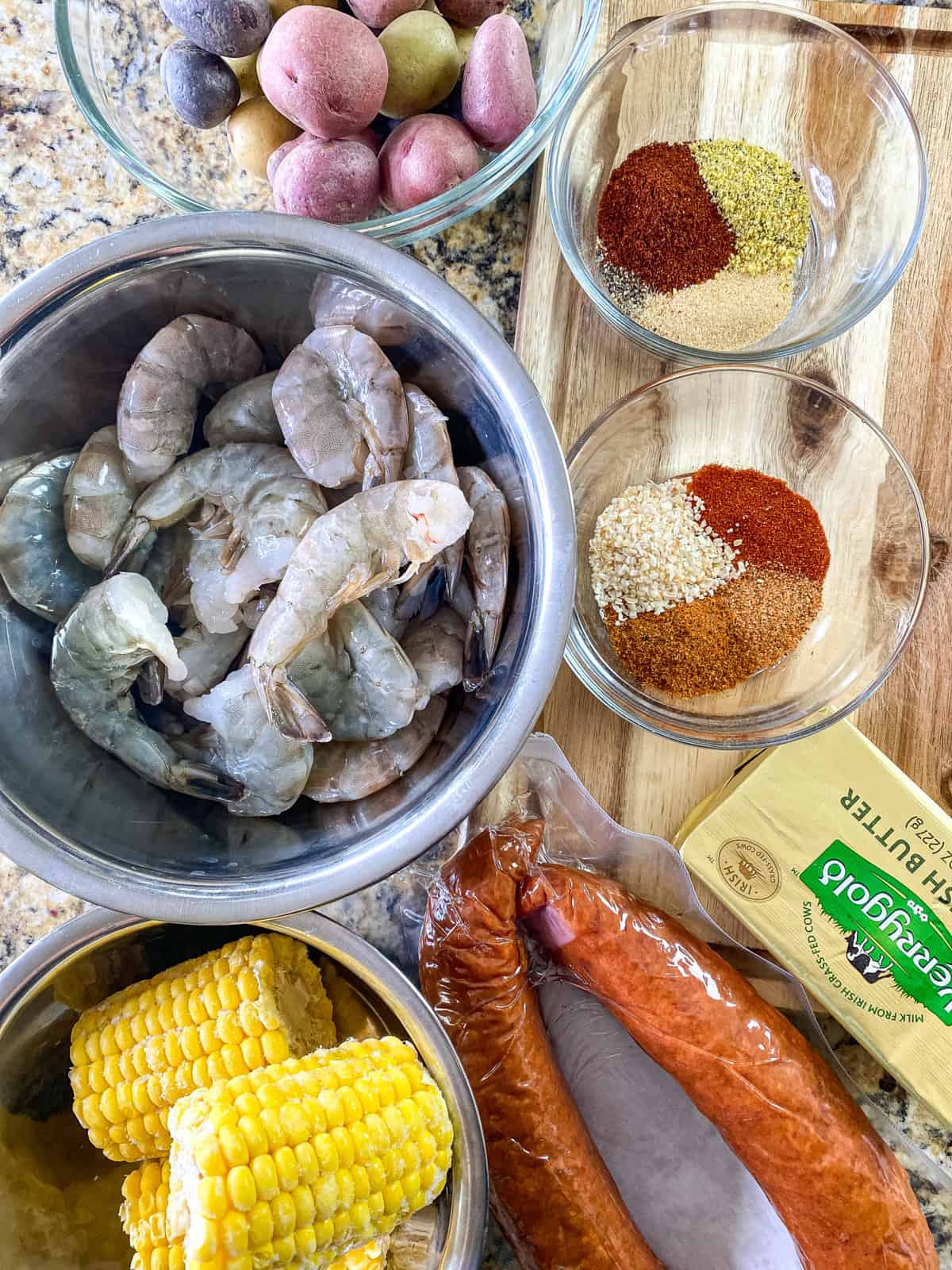 an overhead view of shrimp seasonings sausage and butter for a shrimp boil