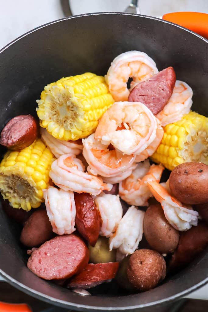 a pot of cooked shrimp sausage and potatoes