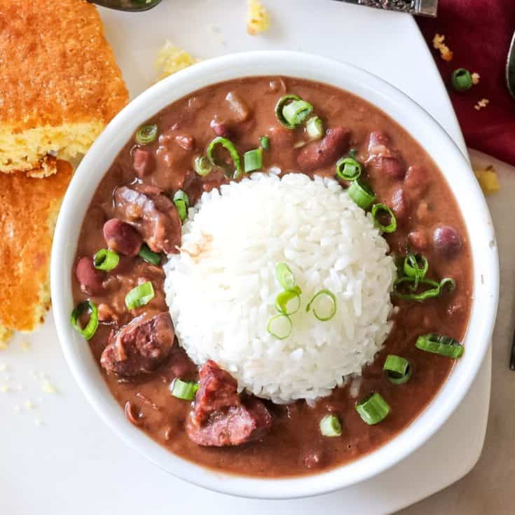 red beans and rice served in a bowl with a side of cornbread on a plate