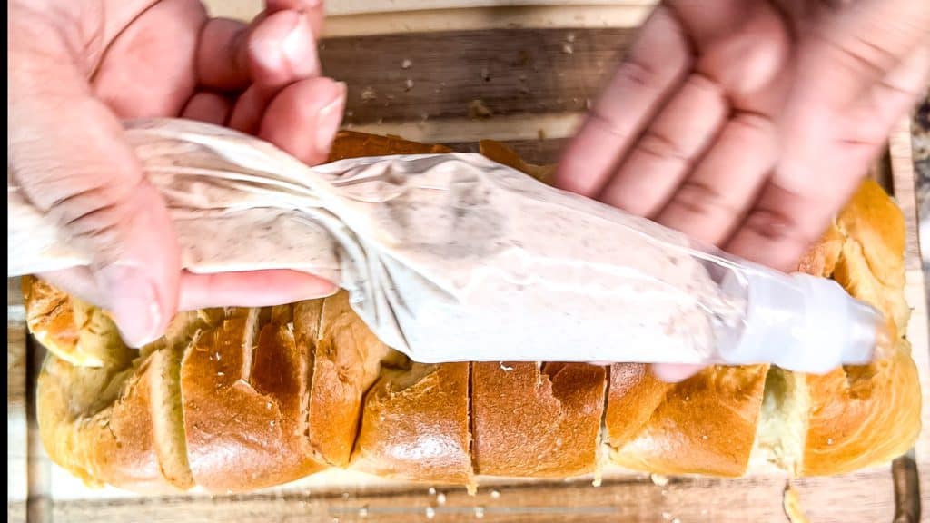 cinnamon sugar mascarpone filling in a piping bag to get ready to stuff French toast