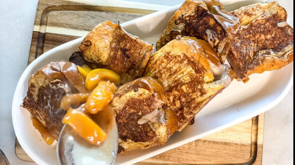 adding the Peach Cobbler filling on top of stuffed French toast