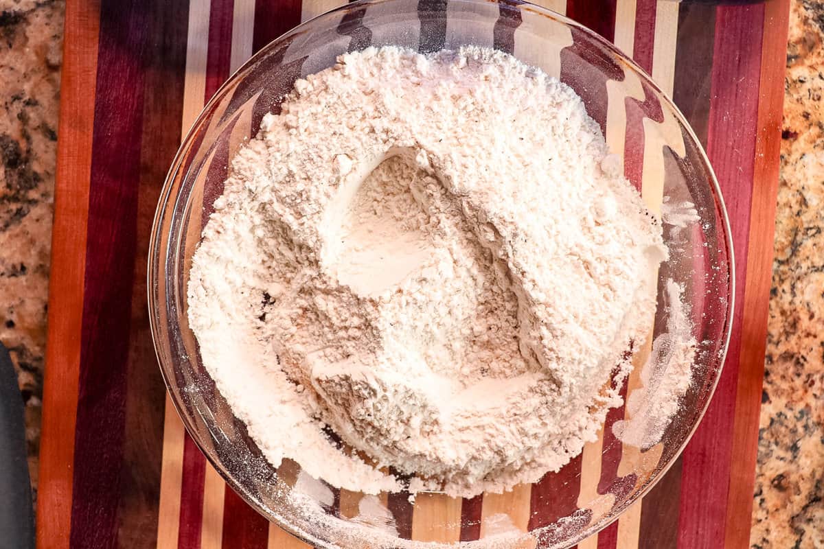 seasoned flour in a dish for the breading component for perfectly seasoned fried pork chops