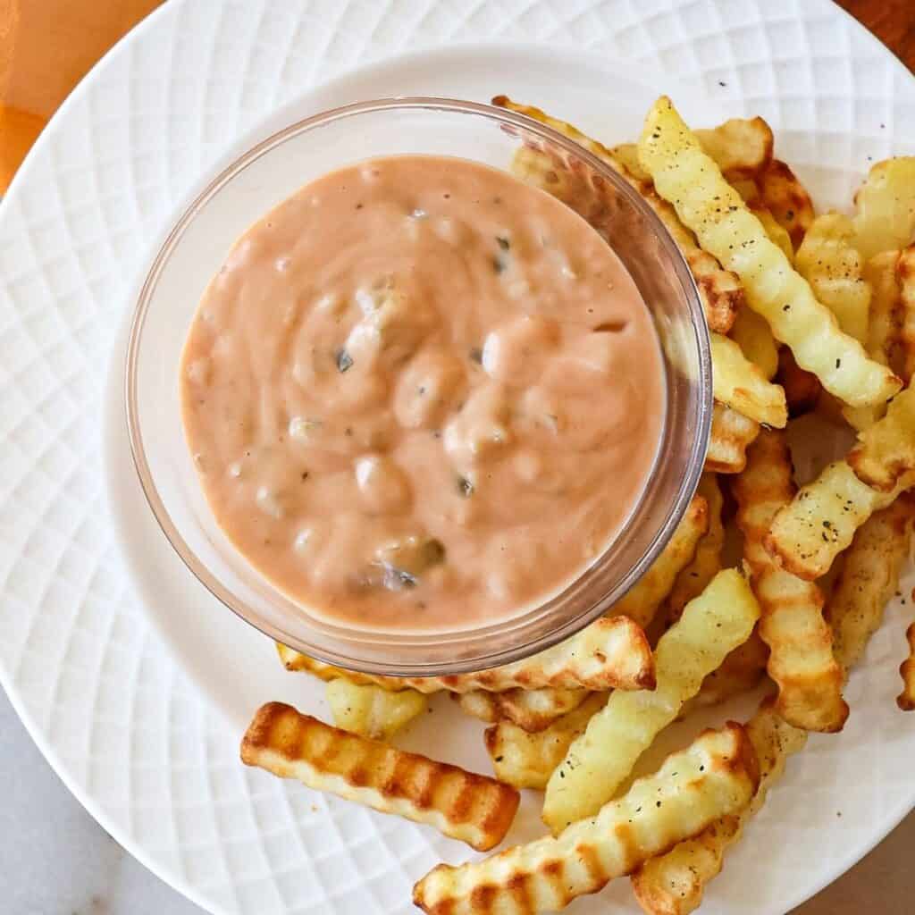 in and out copycat sauce in a bowl surrounded by French fries