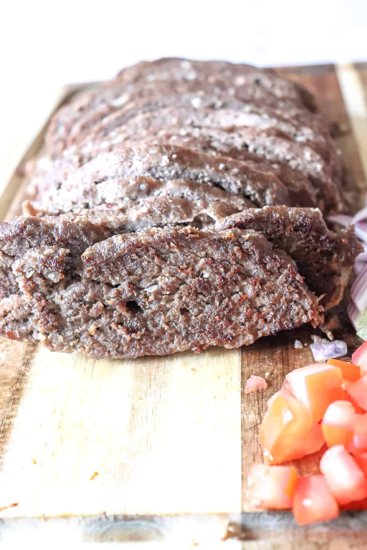 a close-up of gyro meat on a cutting board