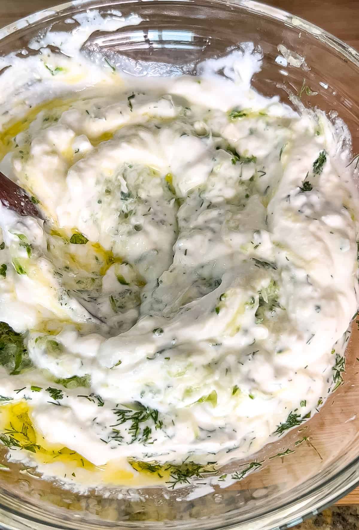 mixing tzatziki sauce in a bowl