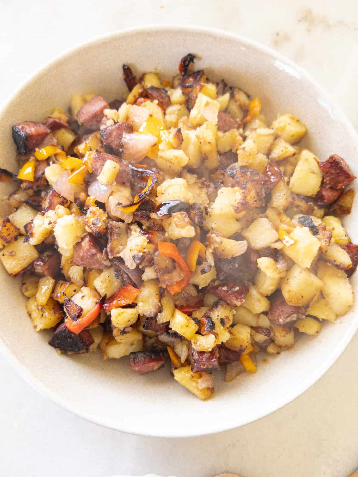 skillet fried potatoes in a bowl with steam coming out