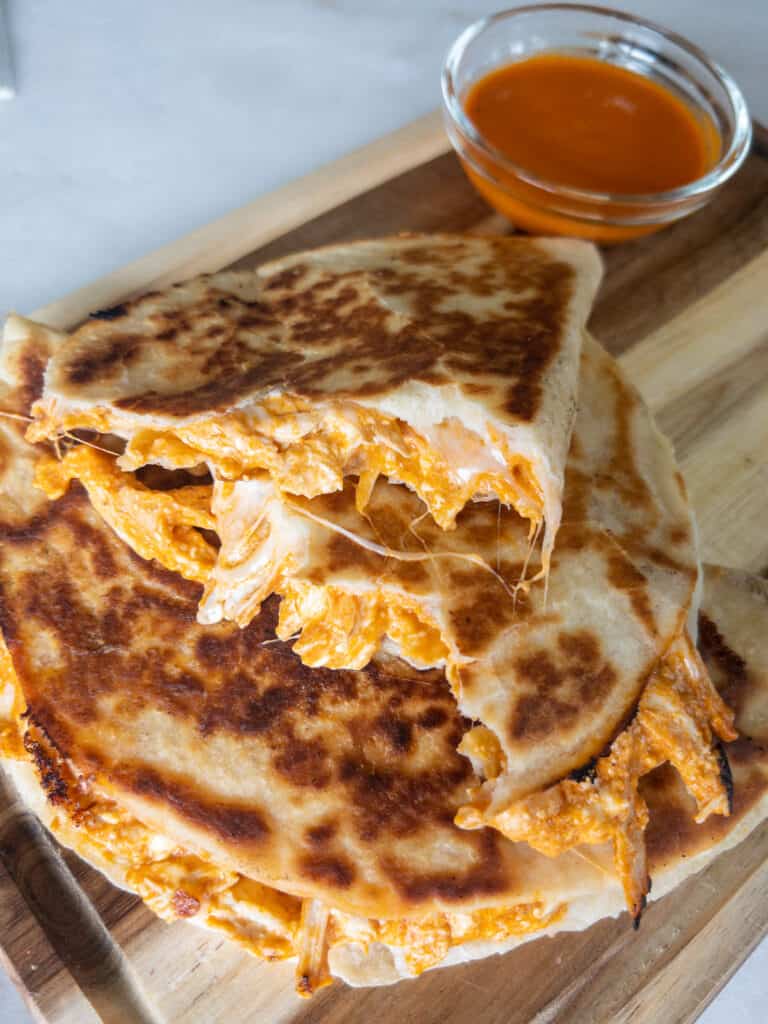 stacked slices of cheesy buffalo chicken quesadilla