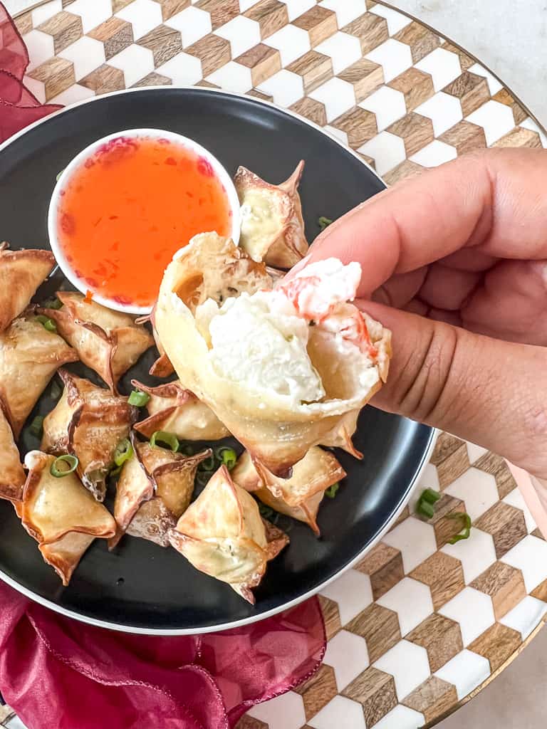 air fryer crab rangoon on a plate with a bowl of sweet chili sauce