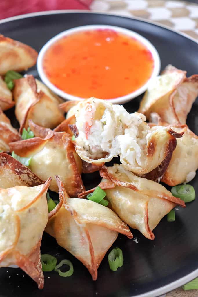 air fryer crab rangoon on a plate with a bowl of sweet chili sauce