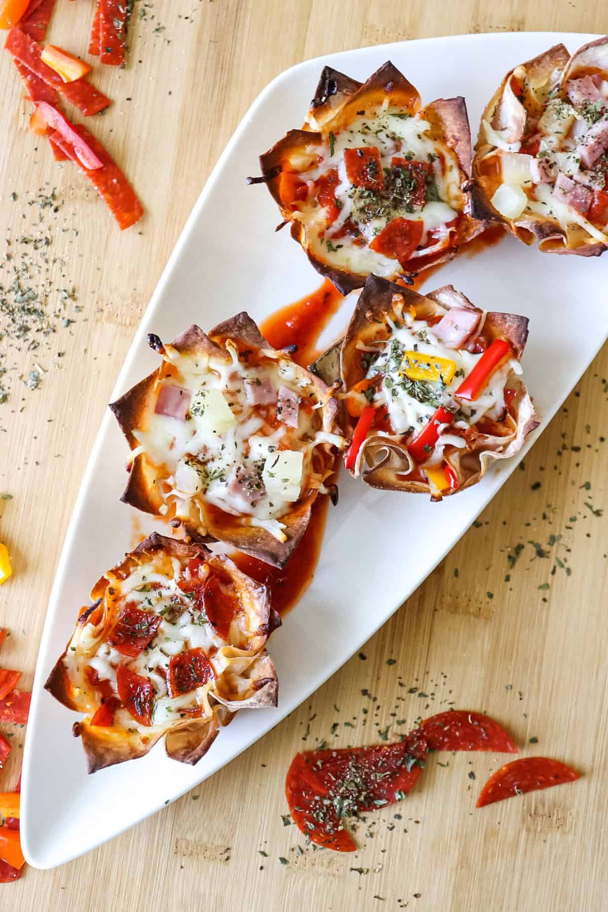 mini pizza cups with pepperoni sitting on a white dish