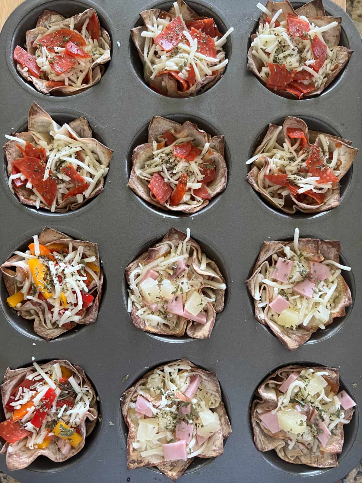 Mini pizzas built in a cupcake pan