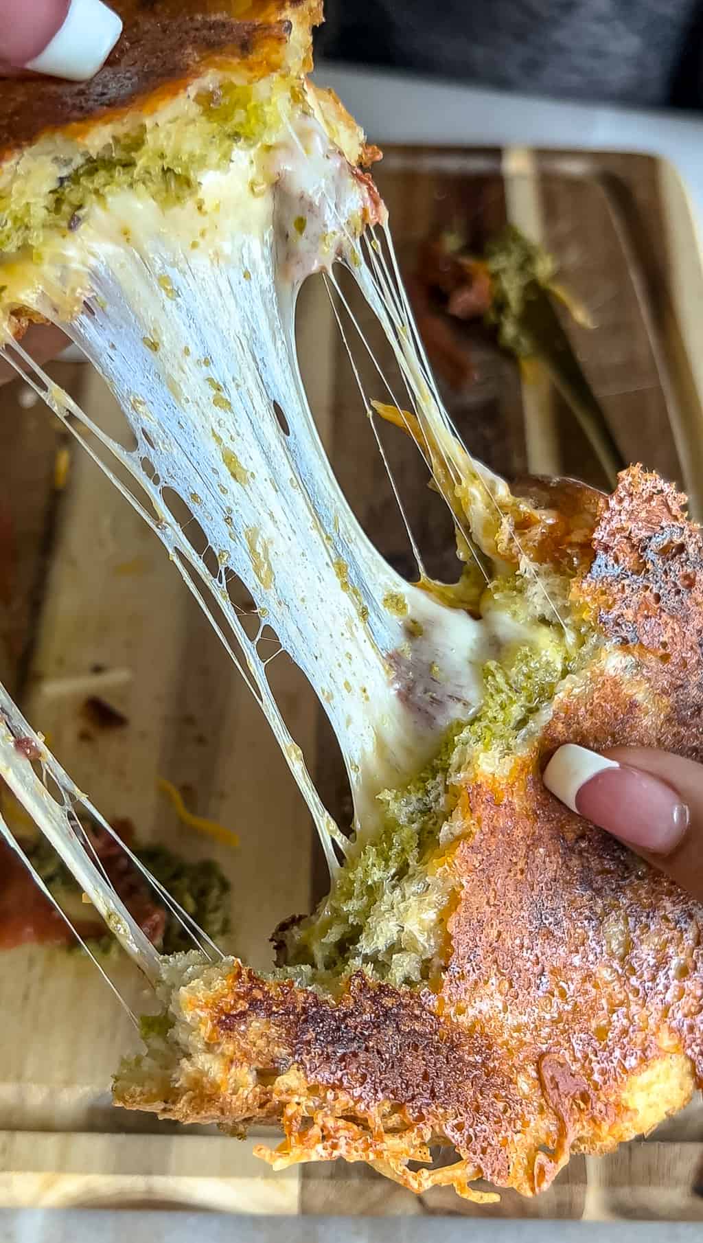 big cheese pull from a pesto grilled cheese sandwich