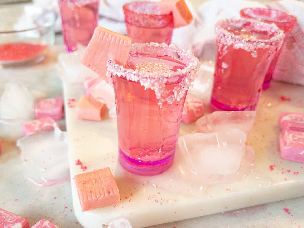 close up view of a pink starburst shot on tray with more