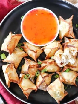 air fryer crab rangoon on a plate with a bowl of sweet chili sauce