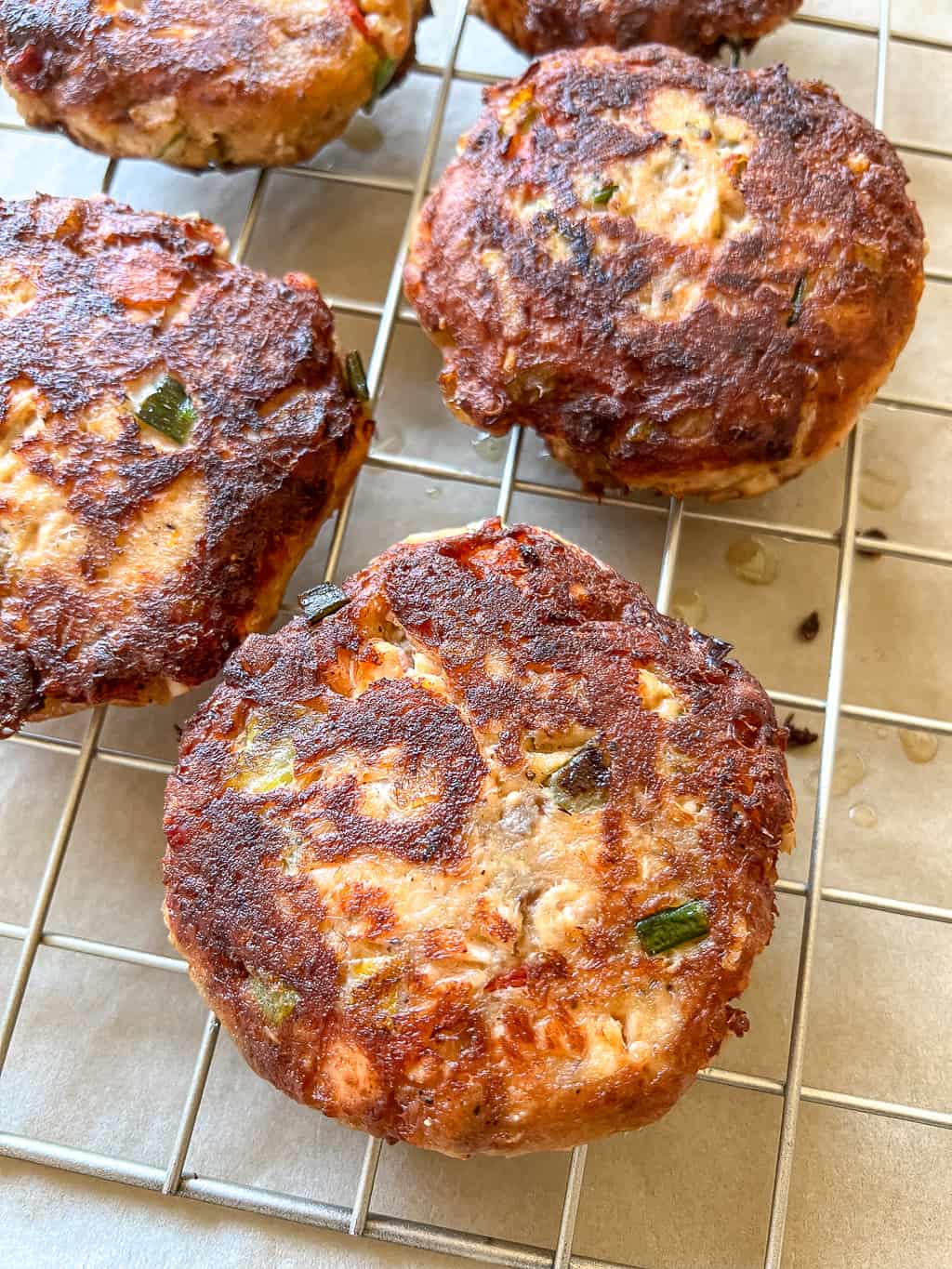 salmon croquettes sitting on a cooling rack