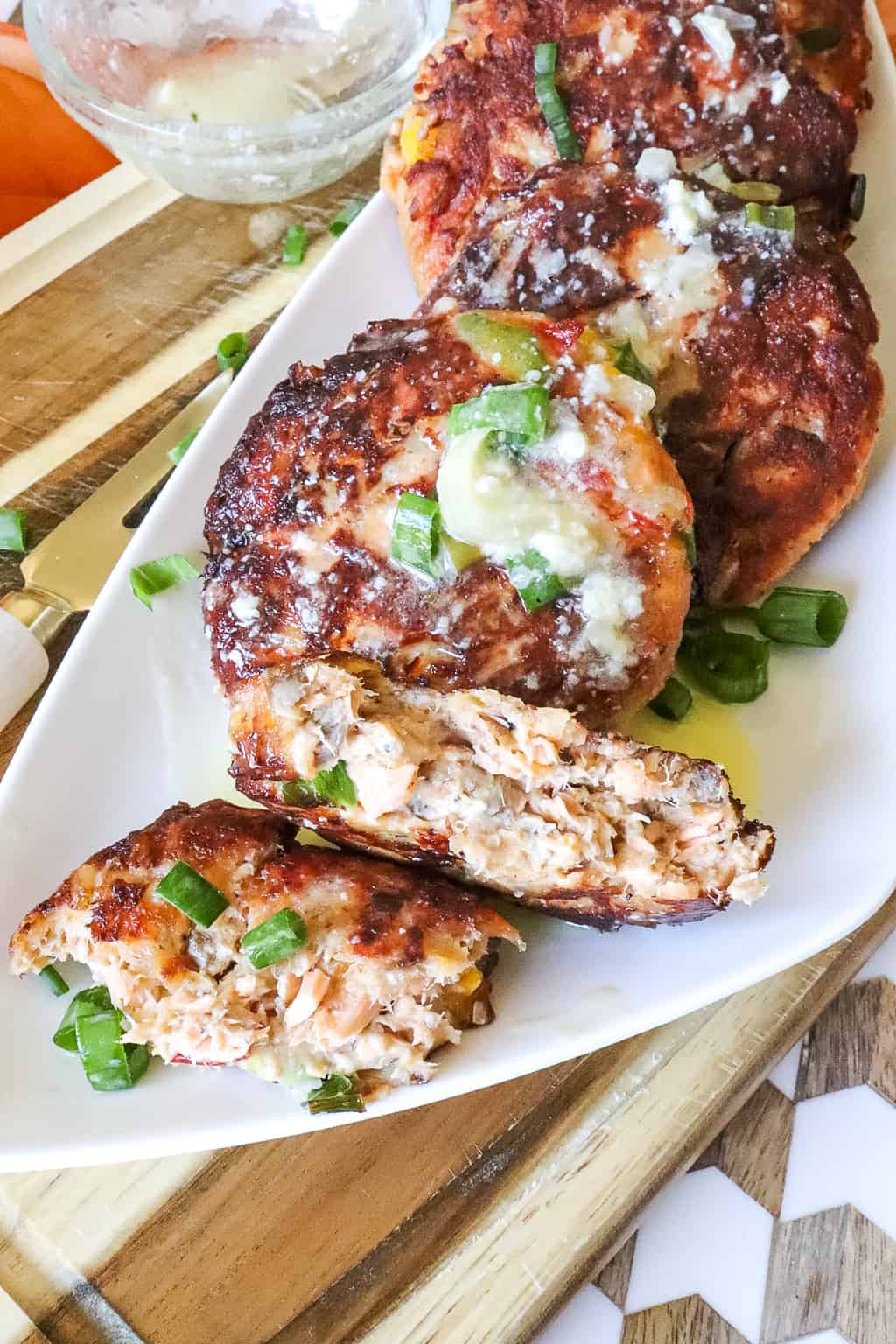 salmon croquettes broken in half on a white dish