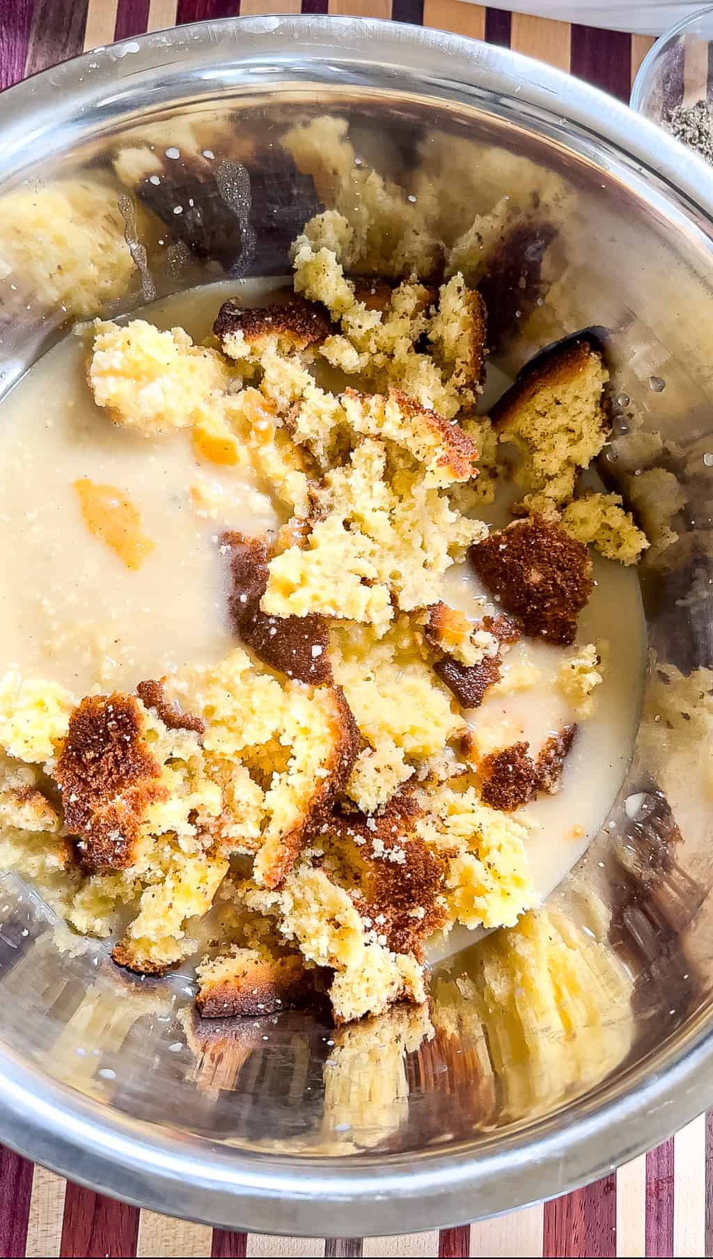 crumbled cornbread in a bowl with chicken broth added