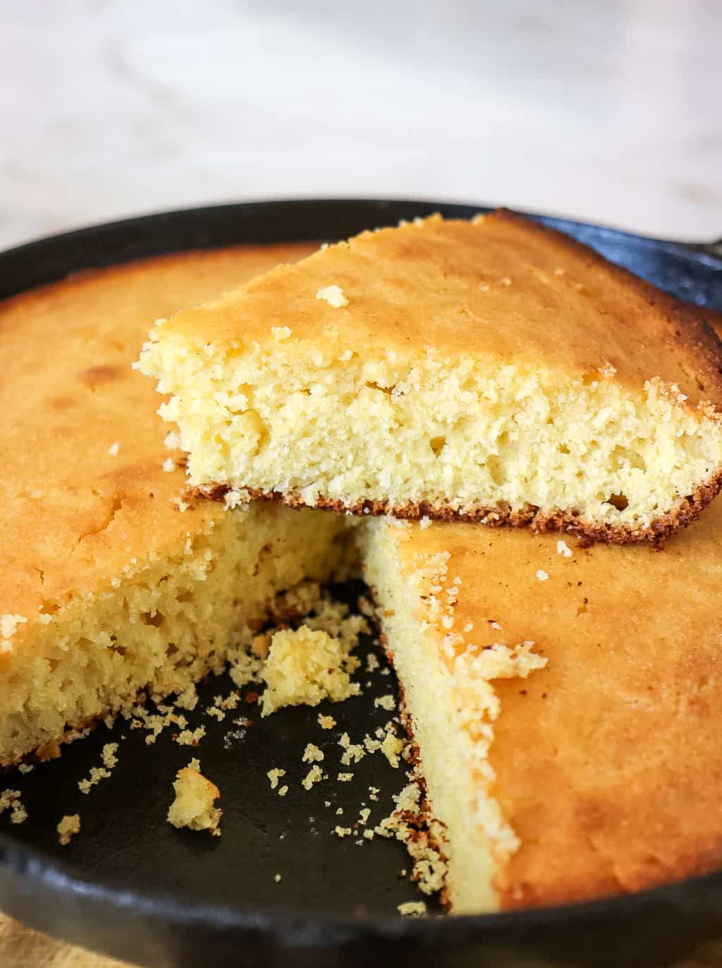 buttermilk cornbread sliced in a cast iron skillet