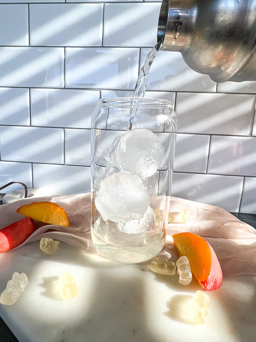 pouring a shot into a cocktail glass