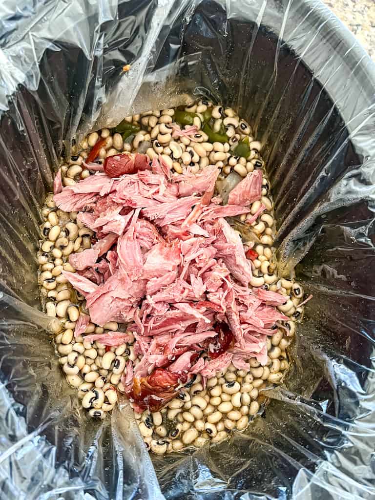 uncooked beans and shredded turkey in a slow cooker