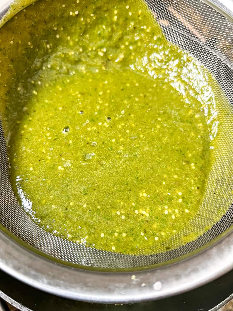 green sauce being strained