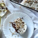 slice of heath bar cake next to a pan of the cake