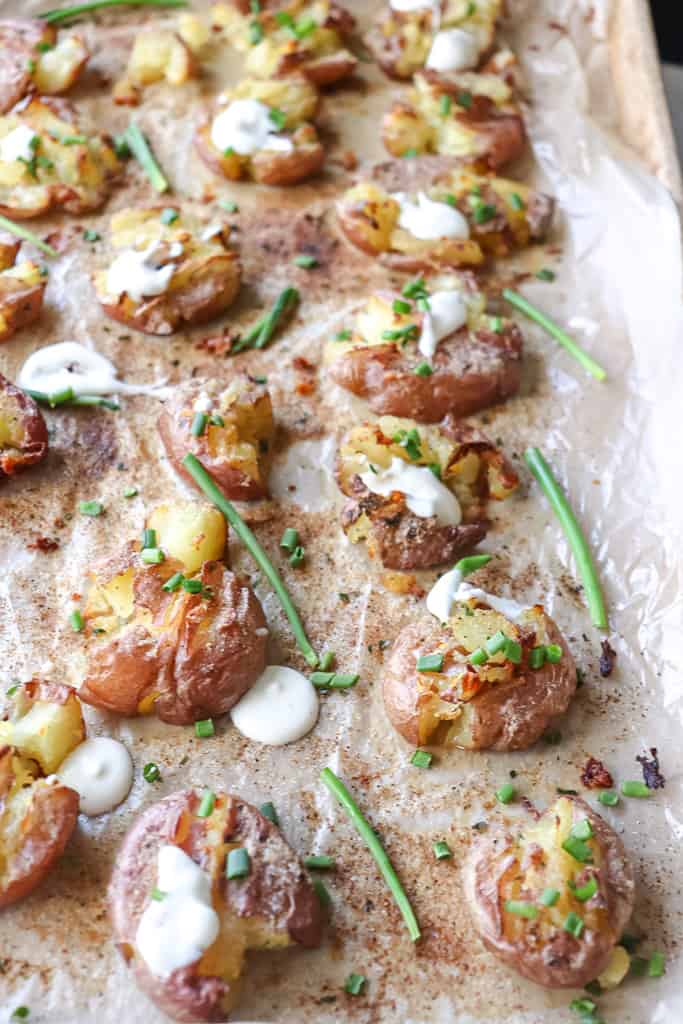 cooked crispy smashed potatoes on a baking sheet