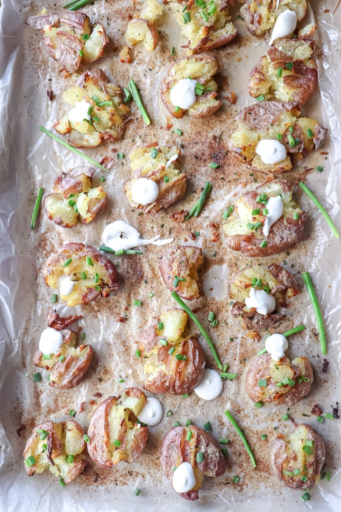 cooked crispy smashed potatoes on a baking sheet