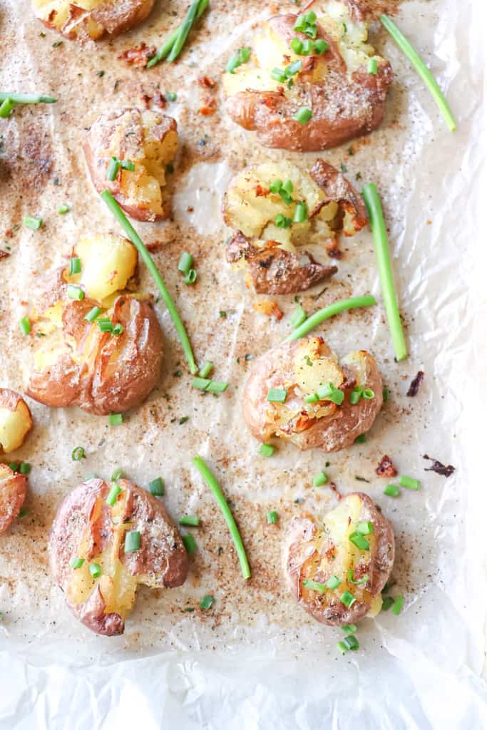 cooked crispy smashed potatoes on a baking sheet