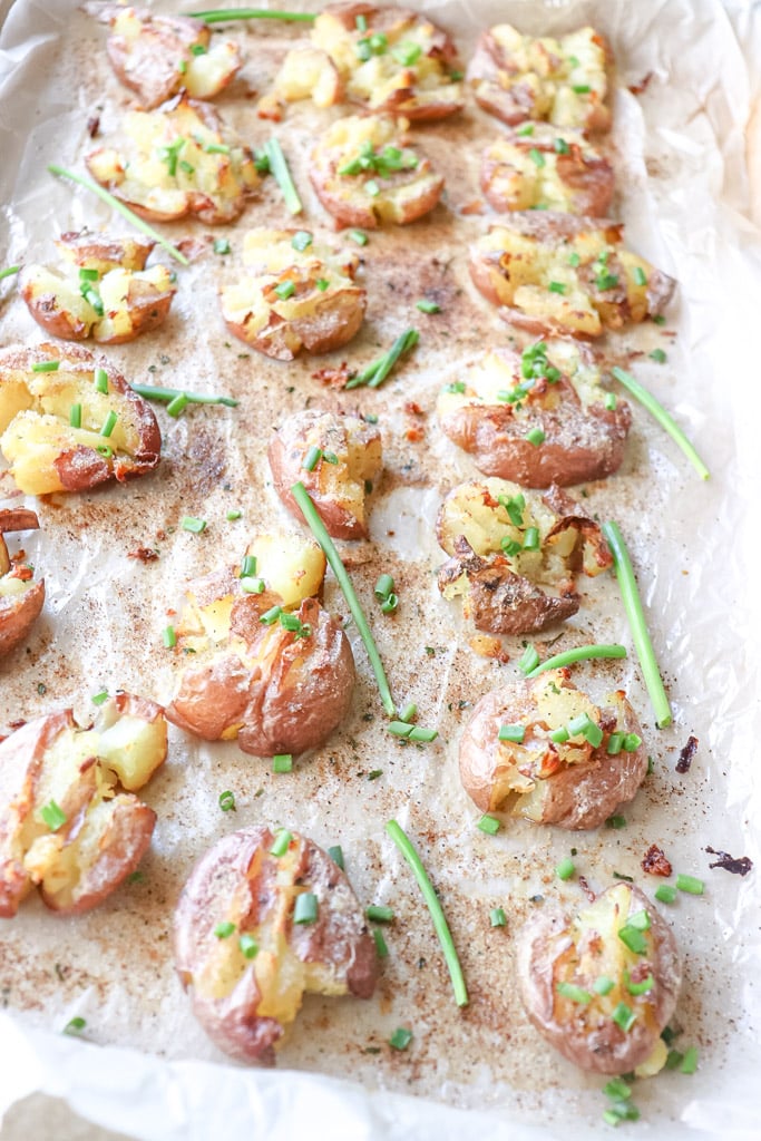 cooked crispy smashed potatoes on a baking sheet