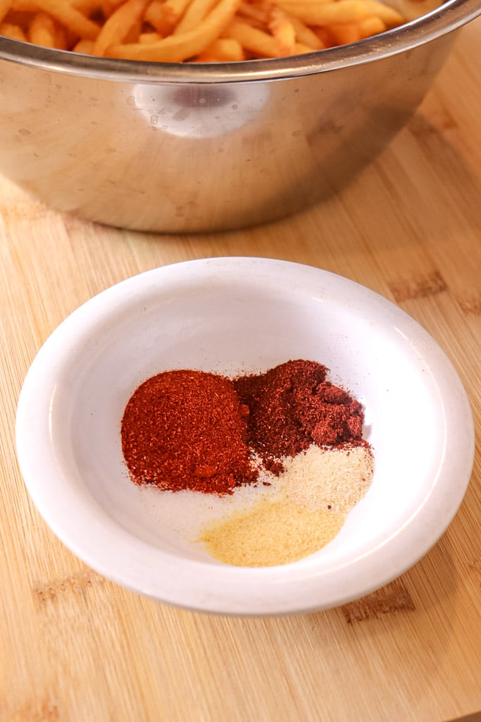 a small bowl of seasoning for fries