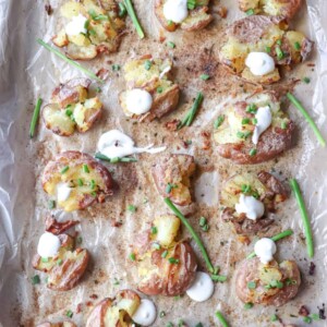 baked smashed potatoes on a baking sheet