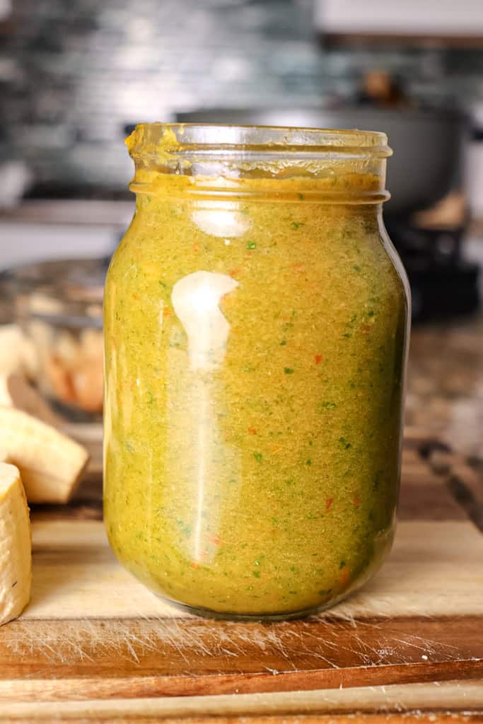 a jar of sofrito on a cutting board