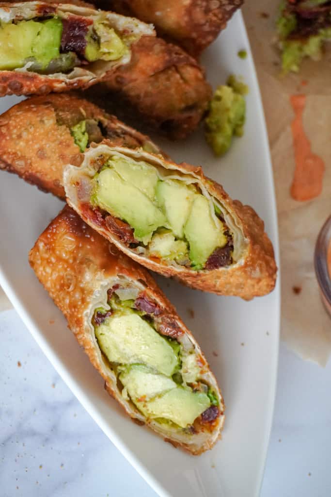 close up view of plated avocado egg rolls