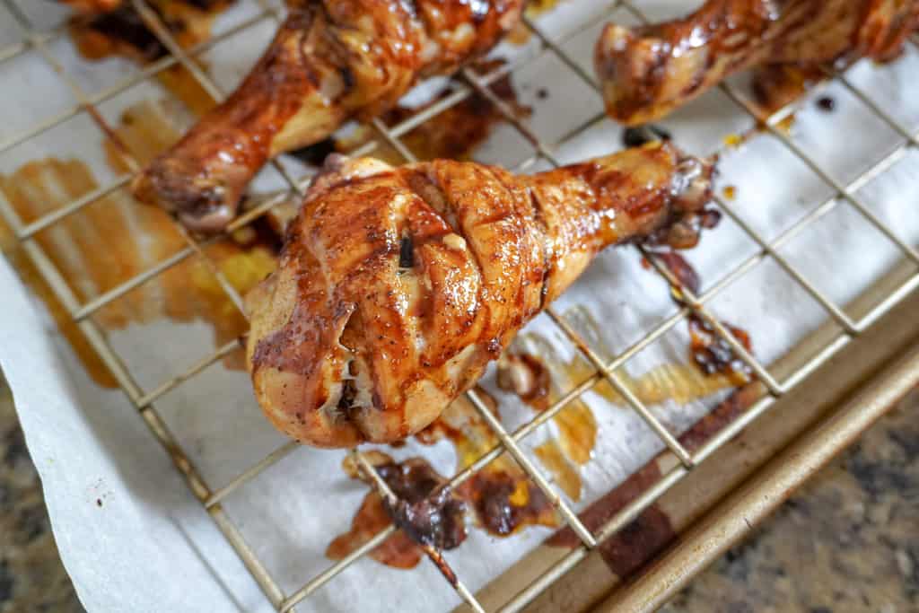 close up view of baked chicken legs half done