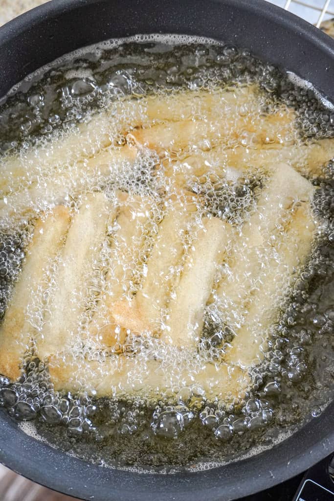 lumpia frying in a pan