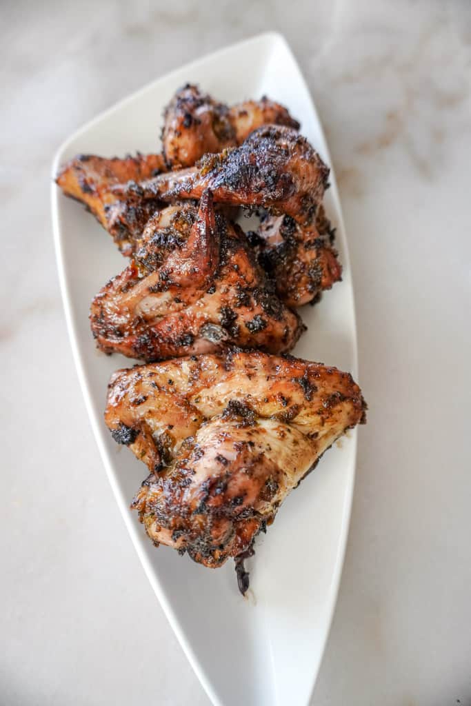 grilled chicken that is sitting on a white plate