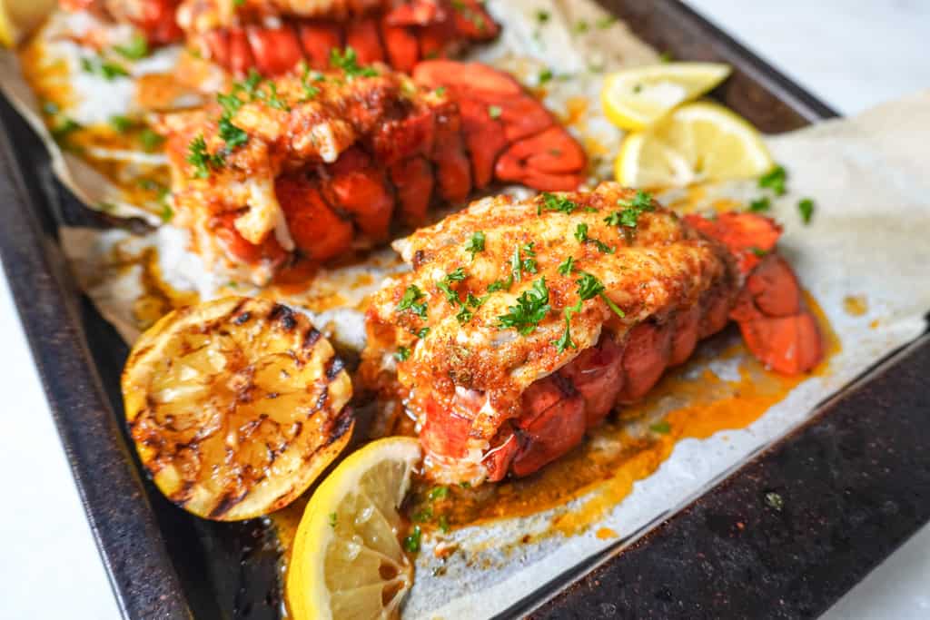 close up view of baked lobster tails on a baking sheet