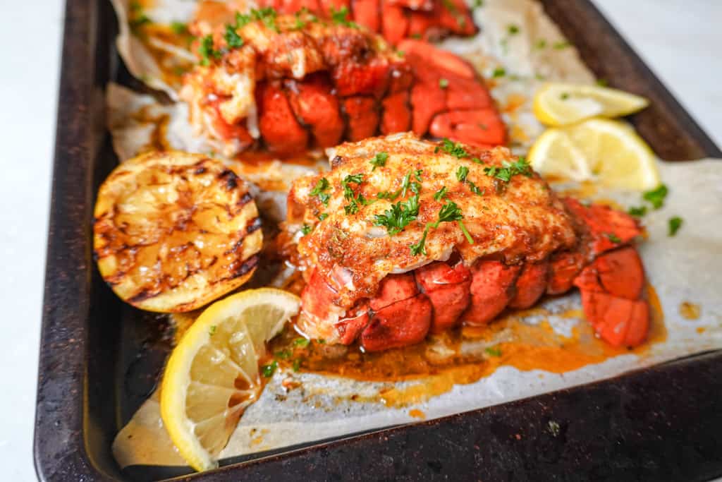 close up view of baked lobster tails on a baking sheet